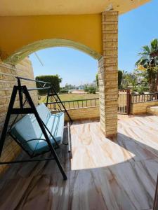 a porch with a hammock on a patio at Chatet on Casabinca NorthCoast in Dawwār Abū Maḩrūs