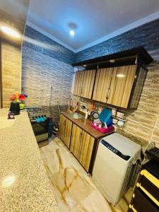 a kitchen with a counter and a refrigerator at Chatet on Casabinca NorthCoast in Dawwār Abū Maḩrūs +2 photos