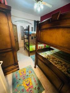 a room with two bunk beds and a rug at Chatet on Casabinca NorthCoast in Dawwār Abū Maḩrūs