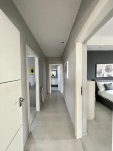 a hallway leading to a bedroom with a bed at Deluxe Appartment in Cinisi