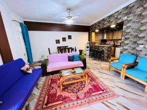 a living room with a couch and two chairs at Chatet on Casabinca NorthCoast in Dawwār Abū Maḩrūs