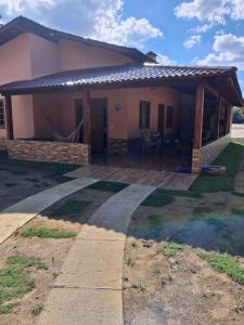 a house with a large deck in front of it at Cottage Saint Antoine in Pedra Azul