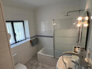 a bathroom with a tub and a sink and a shower at Amaicha Hotel Rural in Ribadesella +73 photos