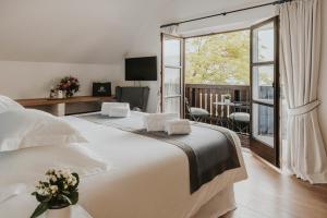 a hotel room with two beds and a balcony at Villa Weiss in Attersee am Attersee