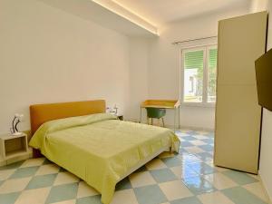 a bedroom with a bed and a desk at Capraia,Elba in San Vincenzo