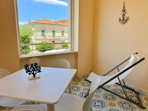 a white table and chairs in a room with a window at Capraia,Elba in San Vincenzo