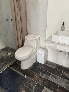 a bathroom with a white toilet and a sink at Aldea Cardumen in Isla Aguada +7 photos