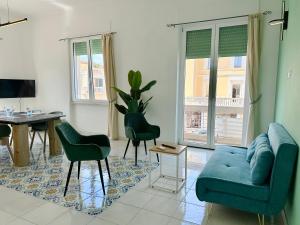 a living room with a blue couch and a table at Capraia,Elba in San Vincenzo