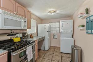 a kitchen with a stove and a refrigerator at Bright 3BR, Dogs, Fenced Yard, FSU & Dwntown in Tallahassee