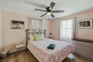 a bedroom with a bed with a ceiling fan at Bright 3BR, Dogs, Fenced Yard, FSU & Dwntown in Tallahassee