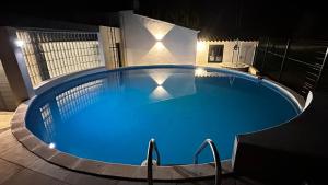 a large blue swimming pool at night at Villa Escaldes in Montroig