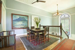 a dining room with a table and chairs at Medindi Manor in Cape Town