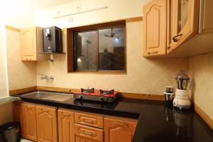 a kitchen with a stove on a counter top at Sheth lov villa in Lonavala +9 photos