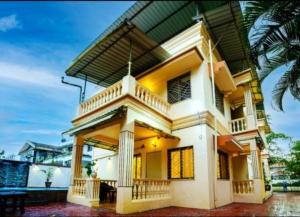 a large white house with a balcony at Sheth lov villa in Lonavala