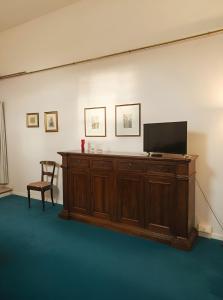 a television on a wooden cabinet in a room at Casa Belvedere - A Due Passi Dal Centro - ItalyWeGo in Narni