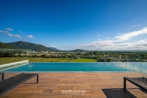 a swimming pool with a view of a city at Cozy Studios in Floripa - OKA in Florianópolis
