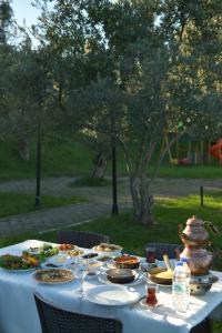 a table with a white table cloth with food on it at Pasha Tatil Köyü in Akcaabat +10 photos