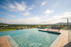 a swimming pool with a bench on top of it at Cozy Studios in Floripa - OKA in Florianópolis