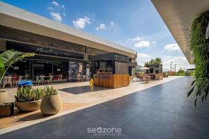 a building with a patio with tables and chairs at Cozy Studios in Floripa - OKA in Florianópolis +288 photos
