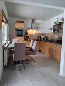 a kitchen with a table and chairs in a room at Waldblick in Marlow