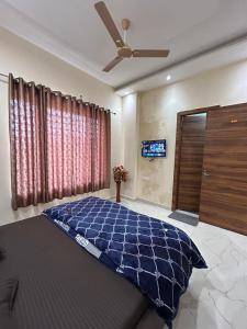 a bedroom with a bed and a ceiling fan at Hotel LD Empire in Amritsar