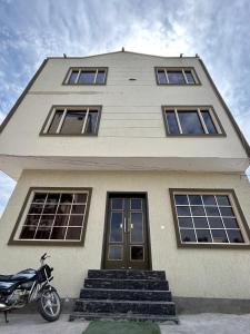 a house with a motorcycle parked in front of it at Hotel LD Empire in Amritsar