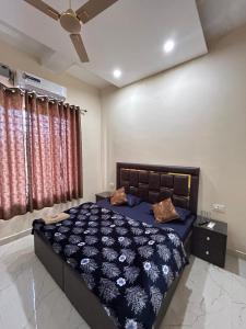a bedroom with a bed with a blue comforter at Hotel LD Empire in Amritsar +21 photos