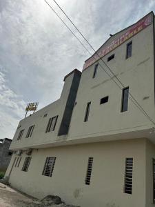 a white building with windows on the side of it at Hotel LD Empire in Amritsar