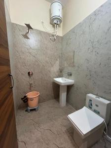 a bathroom with a toilet and a sink at Hotel LD Empire in Amritsar