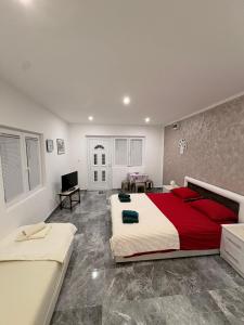 a large bedroom with a large bed and a television at Apartmani Evelin 1 in Veliko Gradište