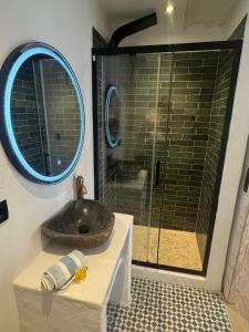 a bathroom with a sink and a glass shower at Puerto de Jávea in Jávea