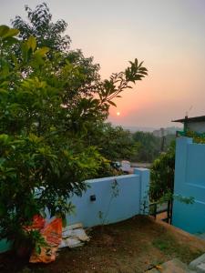 a sunset from the balcony of a house at Mrinal Homestay in Ponda