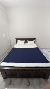 a bed with a blue mattress in a room at Mrinal Homestay in Ponda