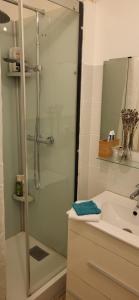 a bathroom with a shower and a sink at Chambre calme Aux Iris in Grandvelle-et-Perrenot