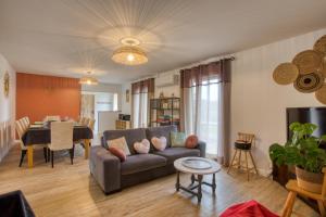 a living room with a couch and a table at Le Nid du Coderc in Carsac-Aillac