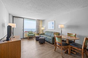 a living room with a couch and a table at The Barclay Towers Hotel and Resort in Virginia Beach