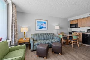 a living room with a couch and a table at The Barclay Towers Hotel and Resort in Virginia Beach