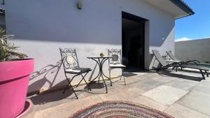 a patio with chairs and a table and a wall at Studio Provence in Istres