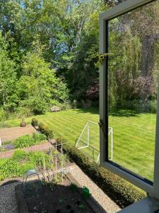 a view of a garden from a window at Bourne House in Mursley