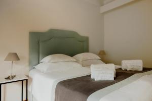 a bedroom with a large bed with white pillows at Villa Weiss in Attersee am Attersee