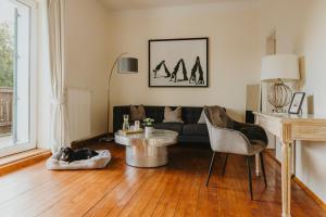 a living room with a couch and a table at Villa Weiss in Attersee am Attersee