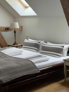 a bed with black and white pillows on it at Ferienwohnungen BH 28 in Traunstein