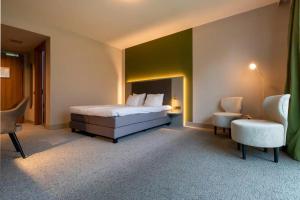 a hotel room with a bed and a chair at Cozmoss Boutique Hotel in Erica