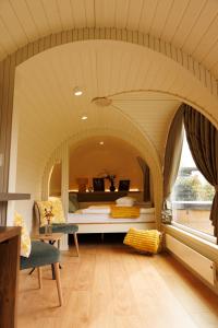 a room with a bed and a table and a window at Feinheit Hotel & Restaurant, Tor zu Hunsrück und Mittelrhein! Mit Sauna Hot Tub und Gartensuite in Halsenbach