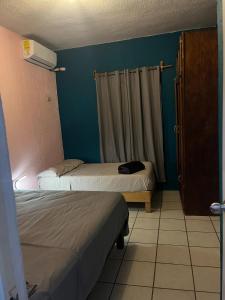 a small room with two beds and a window at Villa Gael Vacation Home in La Paz +17 photos