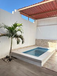 a palm tree in front of a house with a swimming pool at Villa Gael Vacation Home in La Paz