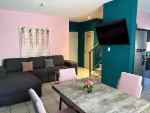 a living room with a couch and a table at Villa Gael Vacation Home in La Paz