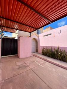 a patio with a red retractable roof on a house at Villa Gael Vacation Home in La Paz