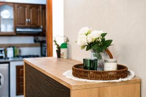 a vase of flowers on top of a table at Elegant & Bright Flat in the Heart of Tangier in Tangier +6 photos
