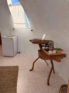 a room with a table and a small refrigerator at Suites Al Mar, en el malecón de San Cristóbal in San Cristóbal